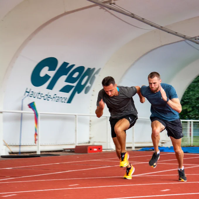 Timothée Adolphe et Charles Renard en train de courir sur une piste de course.