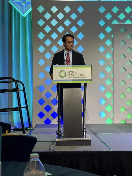 Daniel Tsai speaking at a podium