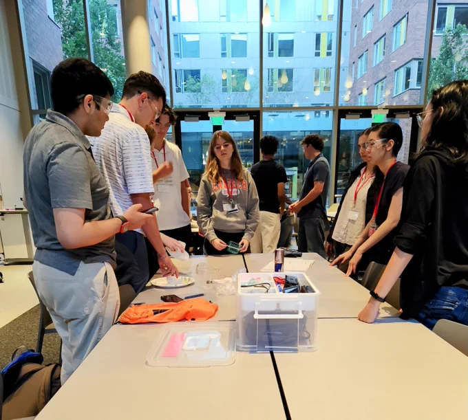 WAS Red Team surrounding a table discussing the engineering challenge.