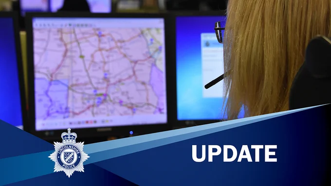 Member of staff with headset working at computer with a map on the screen with the caption 'UPDATE'