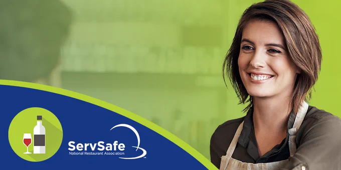 An individual wearing an apron smiles warmly, set against a green background with the "ServSafe - National Restaurant Association" logo prominently displayed on the right. The logo consists of a bottle and a plate icon within a blue and green circle.