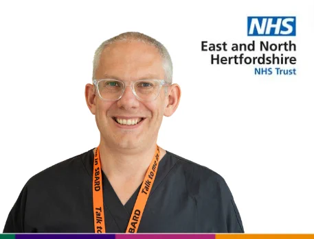 A headshot image of George Stephens, a Advanced Clinical Practice Lead at East and North Hertfordshire NHS Trust. He is smiling toward the camera and wearing uniform.