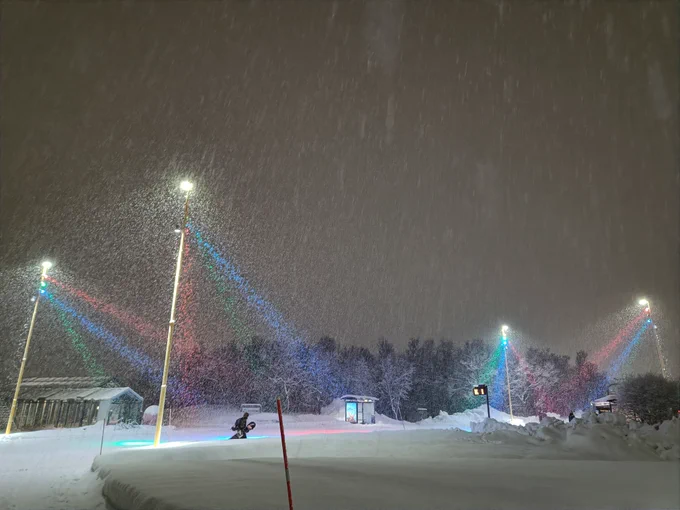 Multicoloured streetlights in a heavy snowfall.