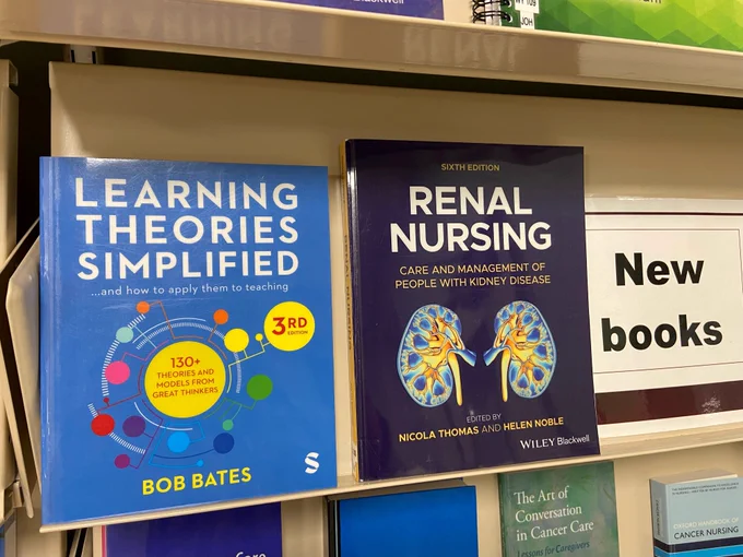 Two new books displayed on a shelf.