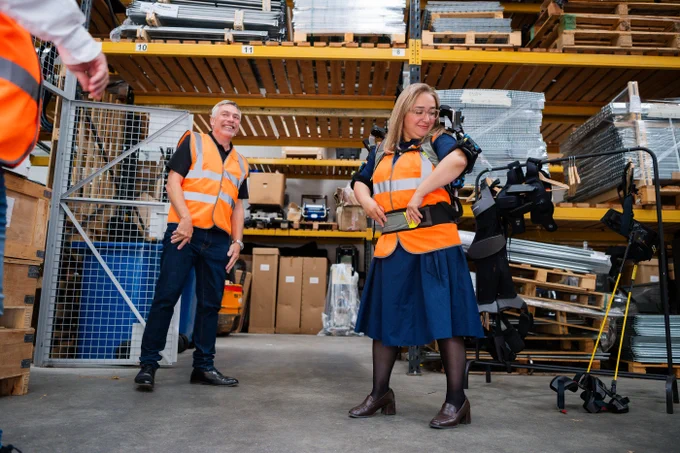 Minister Clark tries on an exoskeleton at Stanley Handling