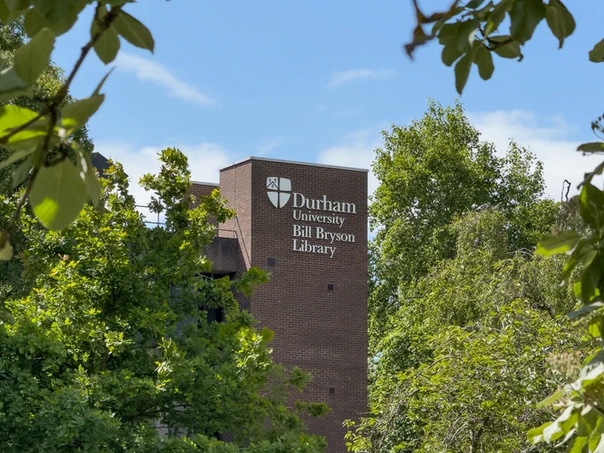 Exterior photo of Bill Bryson Library surrounded by trees.
