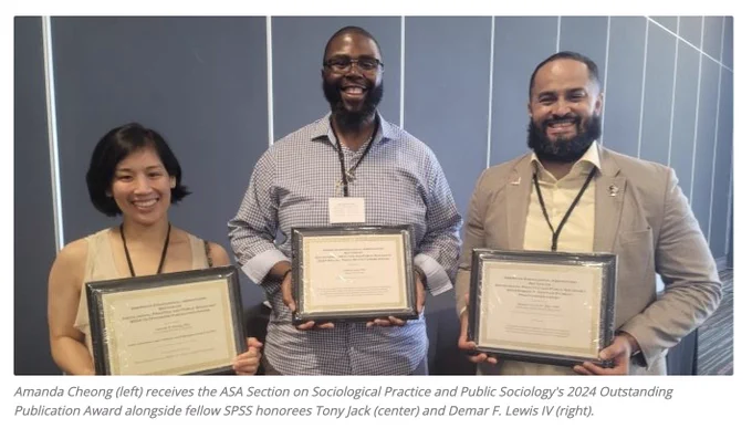 Three scholars, Amanda Cheong, Tony Jack, and Demar F. Lewis IV, beam at the camera. Each person holds a plaque.