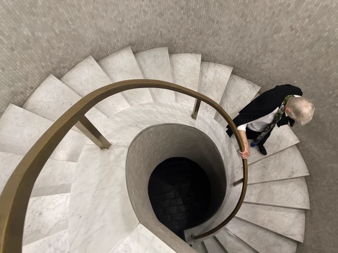 A woman descends the spiral staircase in the RCP.
