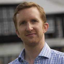 Photo of Paul Kirk, head and shoulders, looking at the camera. 
