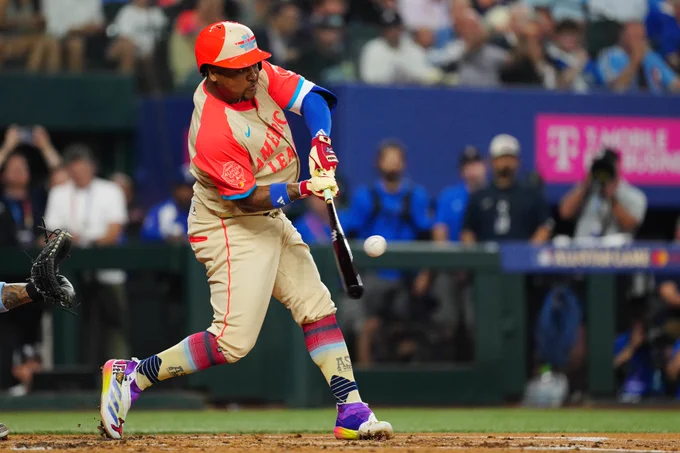José Ramírez swings during the 2024 All-Star Game in Arlington, TX. He is wearing an American League jersey and batting helmet. 
