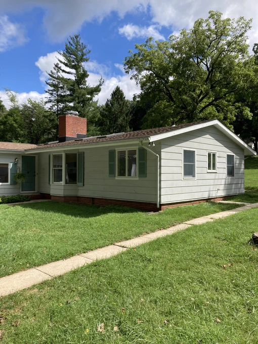 House with grey siding and chimney