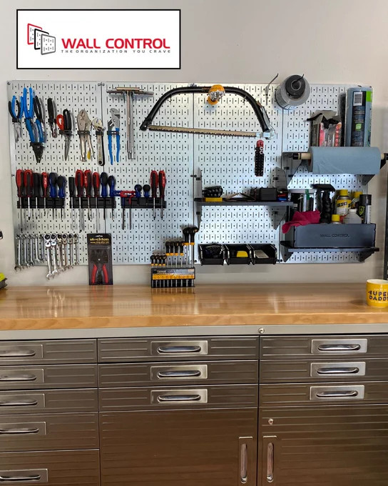 silver metal pegboard panels use a variety of hooks and accessories to hang tools