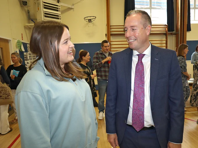 Education Minister Paul Givan pictured at Dromore High School with a pupil receiving GCSE results.