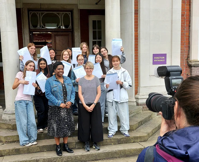 Photo of Parliament Hill GCSE students celebrating their results outside the school with Cllr Sabrina Francis (front left) and Head Sarah Creasey.