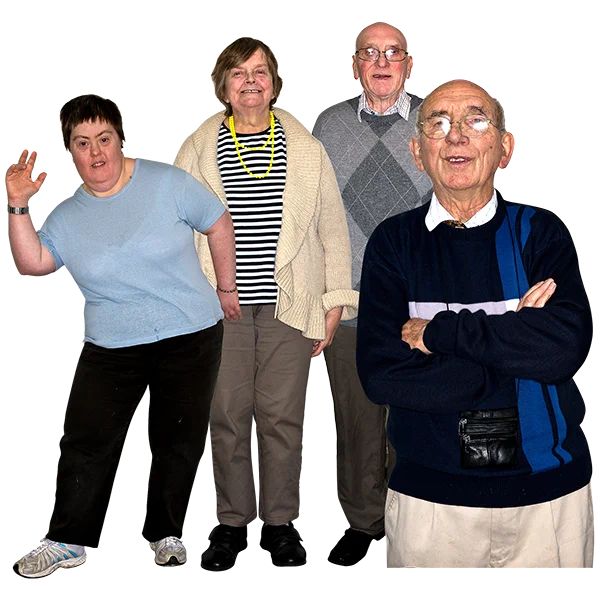 A group of people of different age ranges. One is waving and they are all smiling.