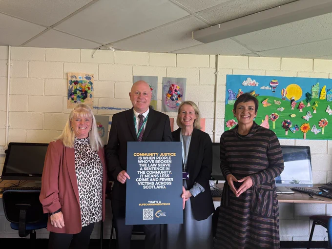 A group photo with Community Justice Glasgow team members and Angela Constance