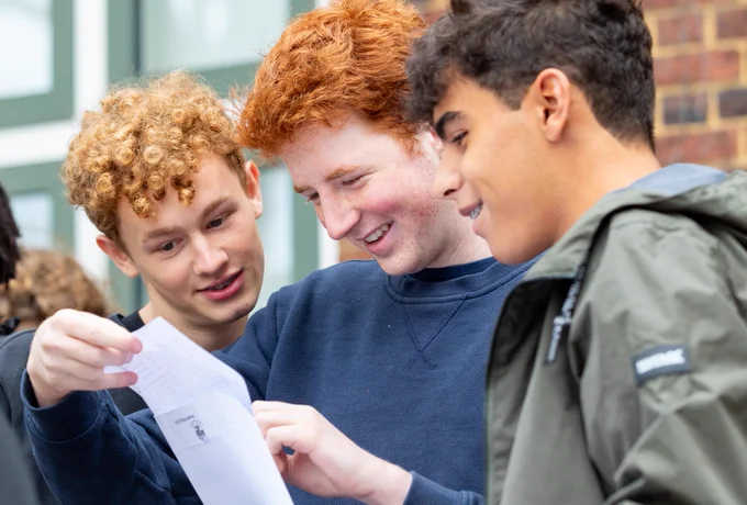 Photo of William Ellis GCSE students Zachary, Anselm and Sam (left to right) celebrating their results today.