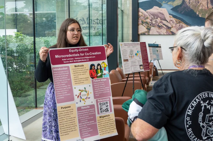 Image of Katie presenting her poster