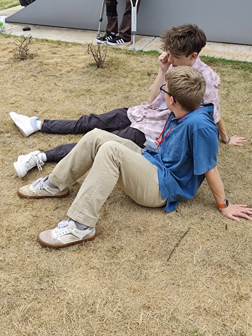 Two Red Scholars feeling their failures after the rocket launch, sitting down on the ground.