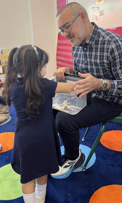 Teacher introducing the Safe Keeper Box as a routine to ensure that He is keeping them safe and they will help keep the classroom safe with him.
