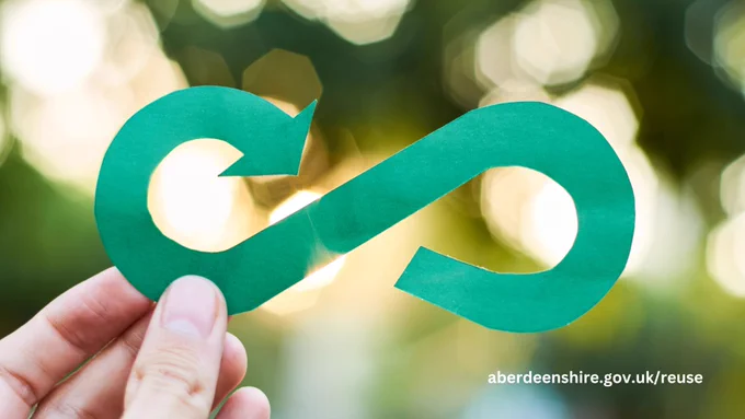 Infinity reuse symbol being held in someone's hand.