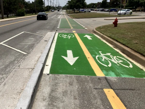 road view of newly paved bike lane with curb protection