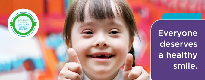 A young girl with Down Syndrome offers a gap-toothed smile to the camera. She's holding both thumbs up. A textbox in the lower-right corner of the image reads, "Everyone deserves a healthy smile."
