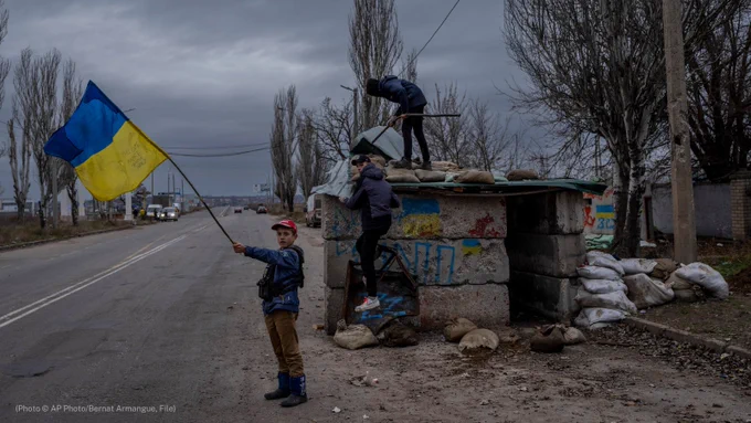 Children play at an abandoned checkpoint in Kherson, southern Ukraine, in November 2022. (© Bernat Armangue/AP)