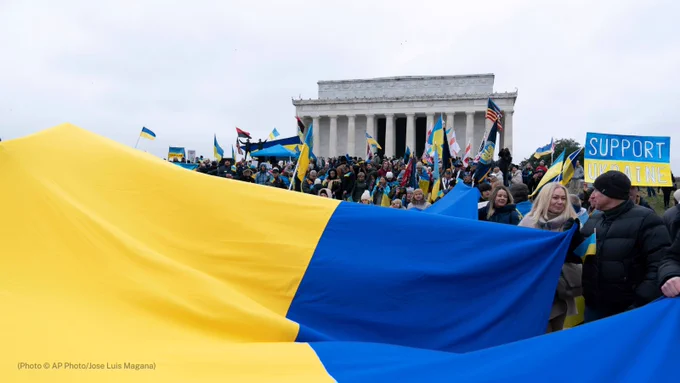 Demonstrators hold a Ukrainian flag as they rally at Lincoln Memorial in support of Ukraine during a rally in Washington, Saturday, Feb. 25, 2023. (AP Photo/Jose Luis Magana)
