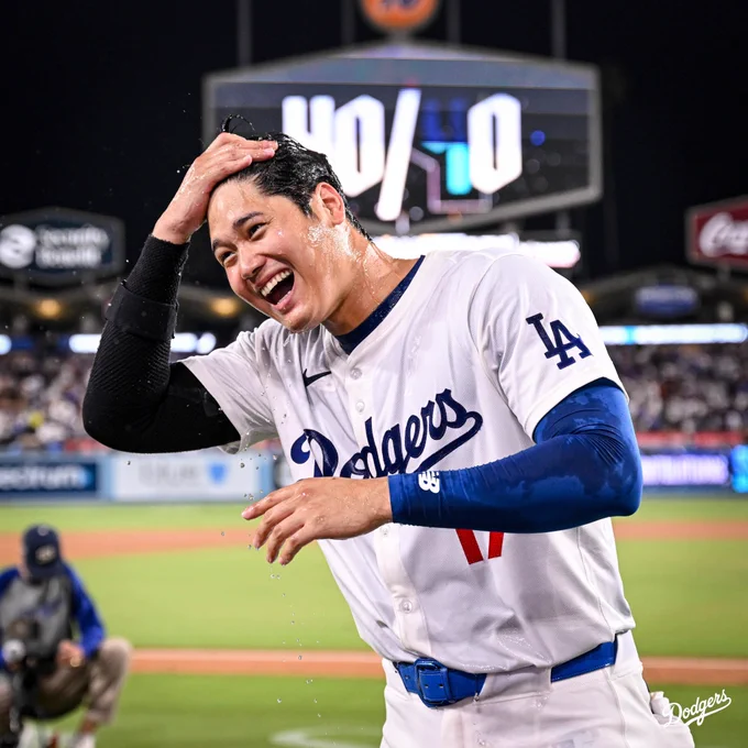Shohei Ohtani smiles after being splashed with water and other drinks.