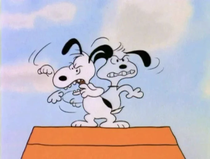 snoopy on his dog house looking around threateningly