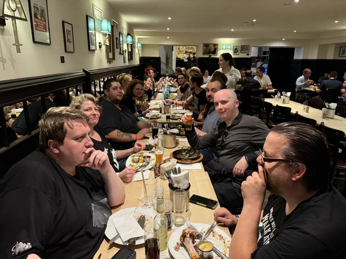 A photo taken at a pub in cologne, showing the long table with 13 SoT Fans