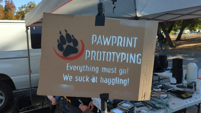 Cardboard spray painted sign. Pawprint Prototyping logo. Everything must go! We suck at haggling!