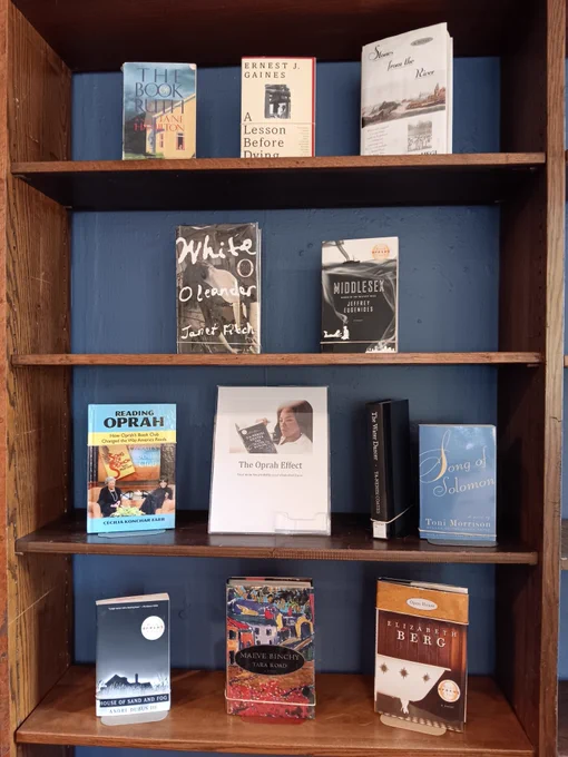 Shelf displaying various books and a sign reading "The Oprah Effect"