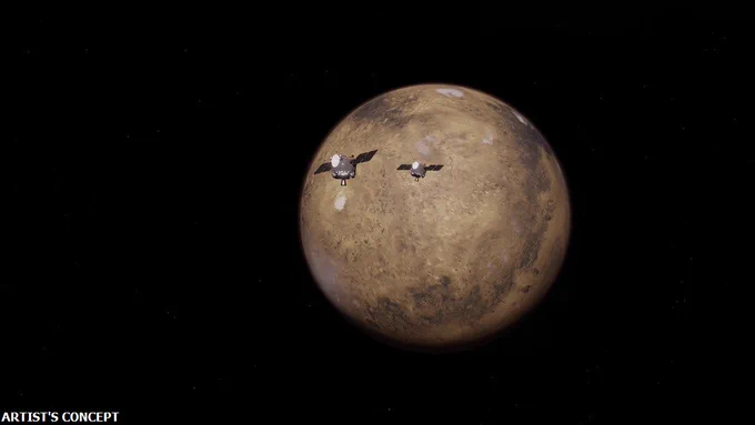 An artist's concept of two small, cubic satellites approaching the planet Mars. The background is completely dark. Credits: James Rattray/Rocket Lab USA