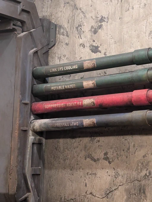 Pipes labeled Link Sys Cooling, Potable Water, Suppression Agent F2, and Compressed Atmo