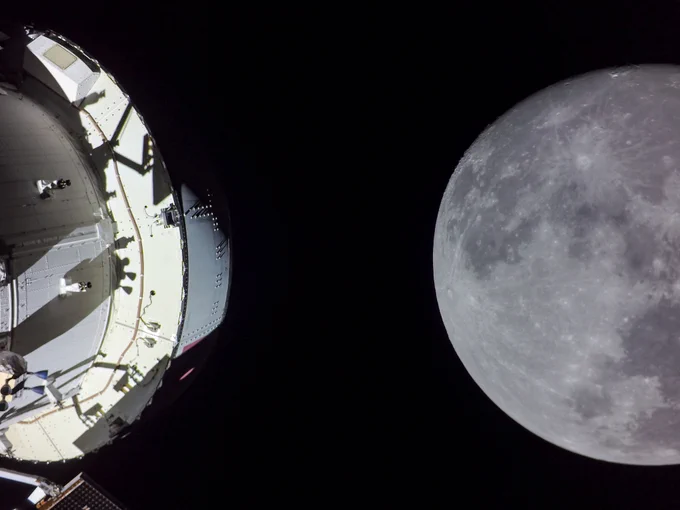 The Moon is seen from cameras onboard NASA's Orion spacecraft during the 20th day of the Artemis I mission. This image was taken after Orion executed the Return Trajectory Correction 3 burn to prepare it for the Return Powered Flyby maneuver, bringing it on its second close approach to the lunar surface and continuing the journey back to Earth. The right side of the image is dominated by the gray, cratered image of the Moon. The left side of the image is dominated by the white outer shell of the Orion capsule. The Moon and Orion stand out against the blackness of space. Credit: NASA