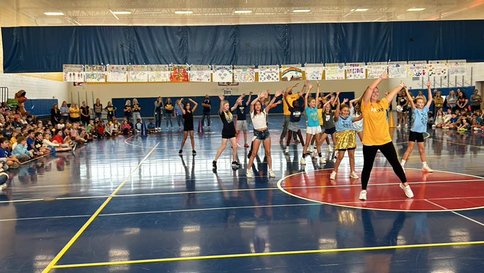Picture of students and staff dancing at Pep Rally.
