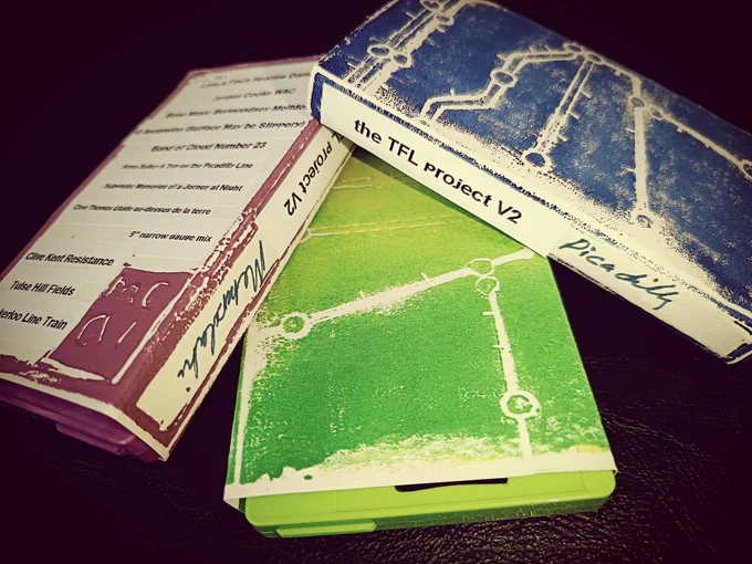 Three Cassette tapes showing the hand crafted card sleeves and 3 colour options: maroon, green and blue 