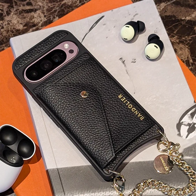 Rose Quartz Pixel 9 Pro in a Bandolier phone case next to a pair of Lemongrass Pixel Buds.