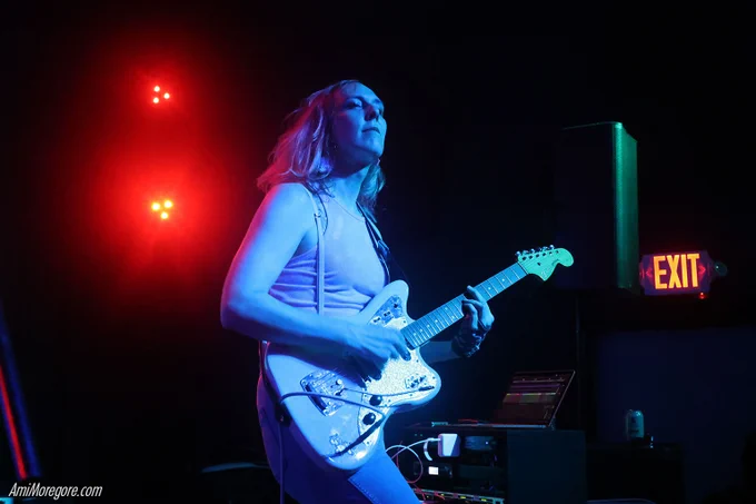 nmlstyl (pronounced "Animal Style") playing guitar on stage
