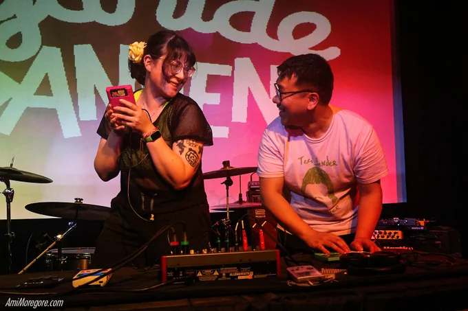 Cyanide Dansen and Flow Mein playing gameboys on stage