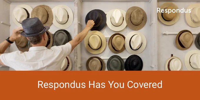 A person is facing a wall of hats, reaching for one to try on