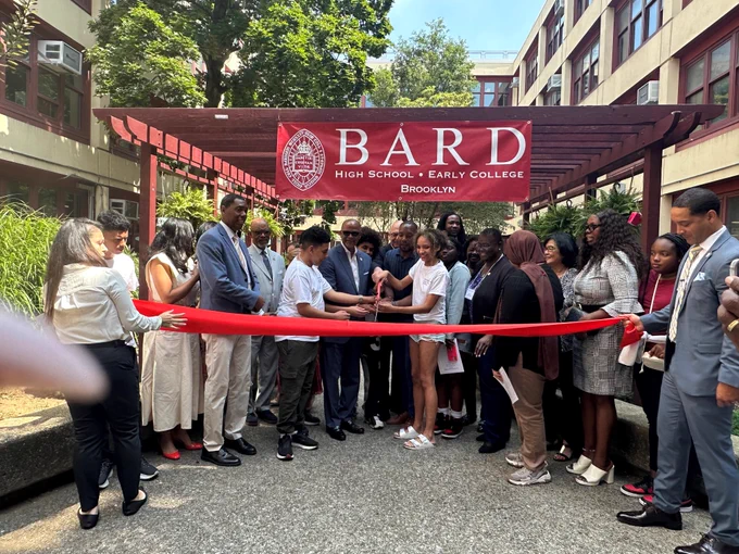 Group of people cutting the ribbon at the Bard High School Early College ribbon cutting ceremony