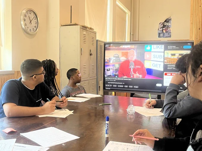 Students watching a video learning about plumbing