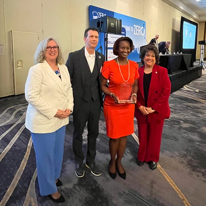 FTA Administrator Nuria Fernandez holds an award with Mary Leary, FTA Associate Administrator, Research, Demonstration and Innovation; Dan Raudebaugh, Executive Director, The Center for Transportation and Environment; and Terry Garcia Crews, FTA Region 3 Regional Administrator.