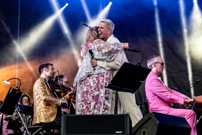 Alison Jiear and Jake Shears embrace onstage alongside Pride Classical orchestra. Photo by Bryan Fowler.
