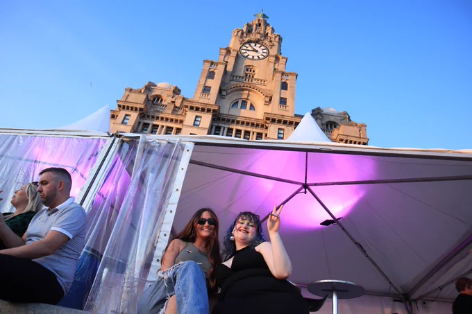 Two friends beneath the Royal Liver Building. Photo by Lewis Jennings.