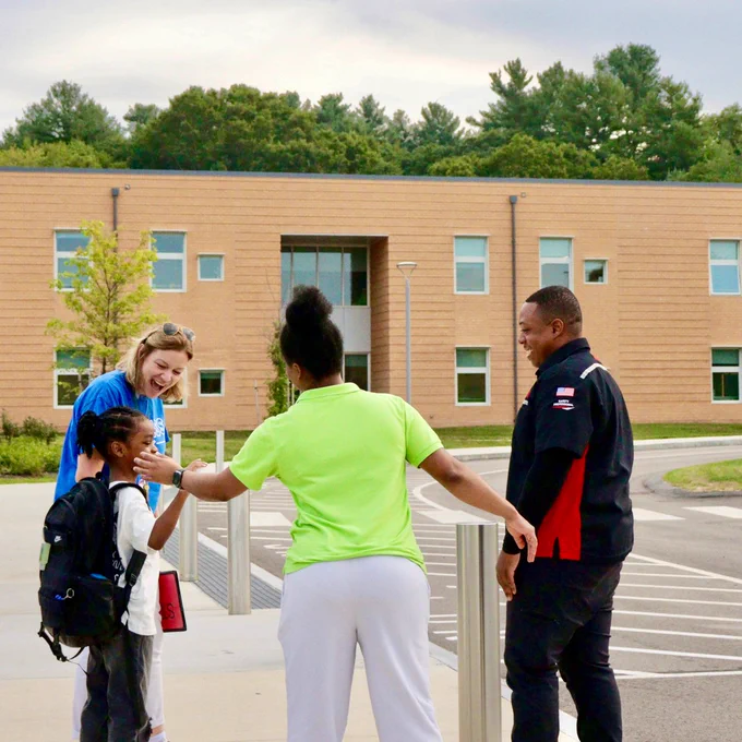 Mindess School Principal Jenna Larrenaga happily welcomes a student and their parents for the first day of school