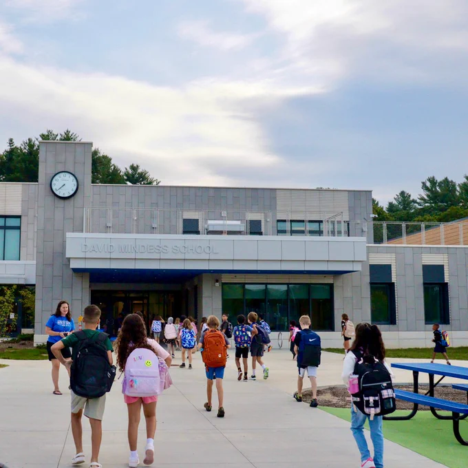 A crowd of Mindess School students walks into the building for their first day of school